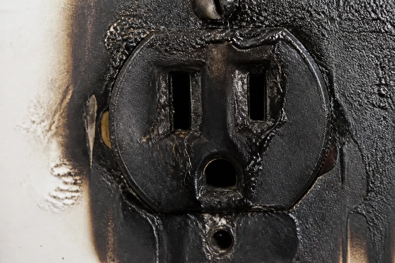 Melted scorched electrical outlet on a Tampa home wall